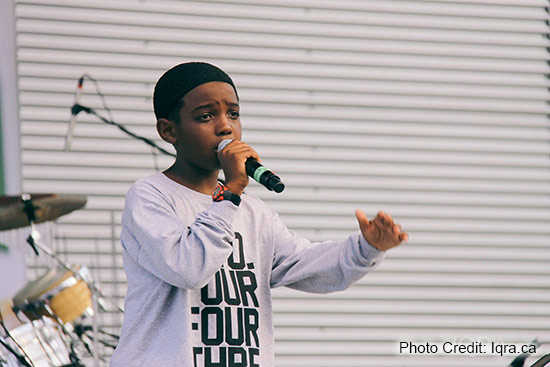 A young member of the Canadian hip hop group Mustaqeem performs