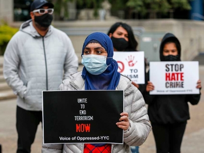 People attend a vigil to honour the memory of the four members of Muslim family that died in an attack on June 6, 2021.