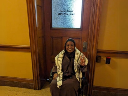 MPP Sarah Jama wearing a Keffiyeh in front of her office at the Ontario Legislature