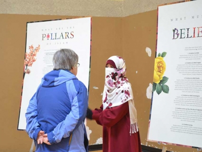 A volunteer discusses Islam with a visitor to her local mosque in British Columbia on February 16, 2019.