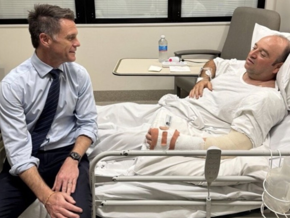 Ahmed al Ahmed, pictured here in a hospital bed, received a visit from New South Wales Premier Chris Minns