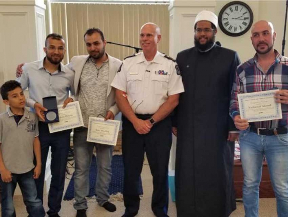 Nashwan Ahmed, Ibrahim Manna, and Raed Abualhaj with Halifax Police Chief Jean-Michel Blais and Imam Abdallah Yousri