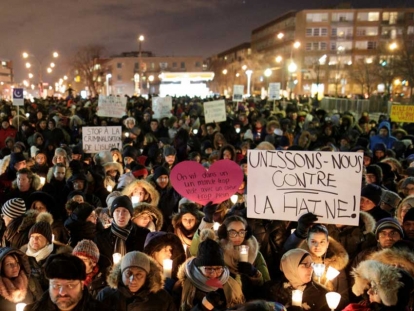Here people attend a Montréal vigil for the Québec City victims on January 30, 2017