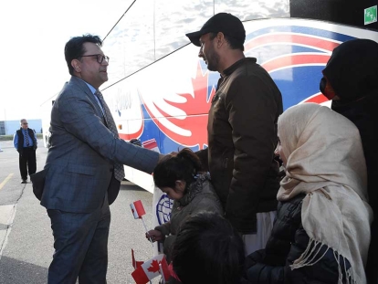 Member of Parliament Masjid Jowhari greets the latest newcomers arrived in Toronto, Ontario, on a charter flight from Pakistan and include Afghans who supported Canada’s mission in Afghanistan, family members of former Afghan interpreters, and privately sponsored refugees arriving through the humanitarian stream.