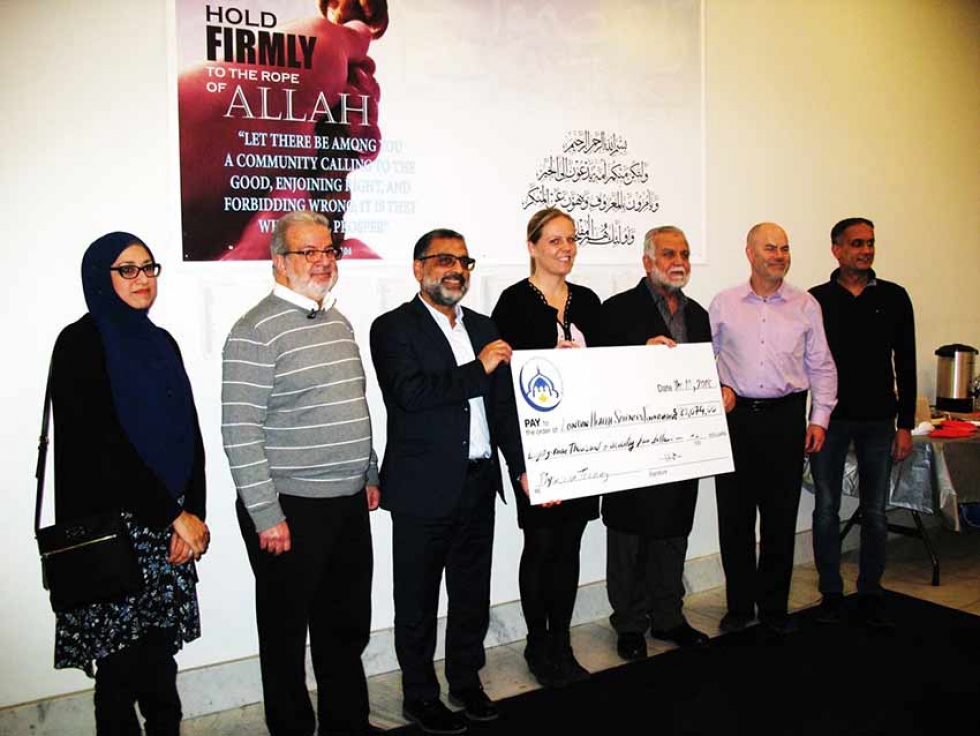 Members of the London Muslim Mosque present a donation to the London Health Sciences Foundation for the education of a doctor from Gaza.