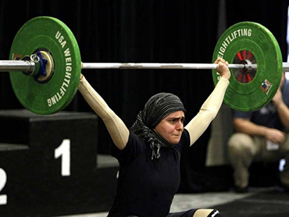 Muslimah weightlifter Kulsoom Abdullah at the USA National Weightlifting Championships last summer.