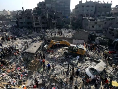 Palestinians look for survivors under the rubble of destroyed buildings following Israeli airstrikes on the Jabaliya refugee camp in northern Gaza.