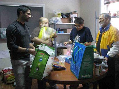 Sadaqa Food Bank volunteers sort food donations.