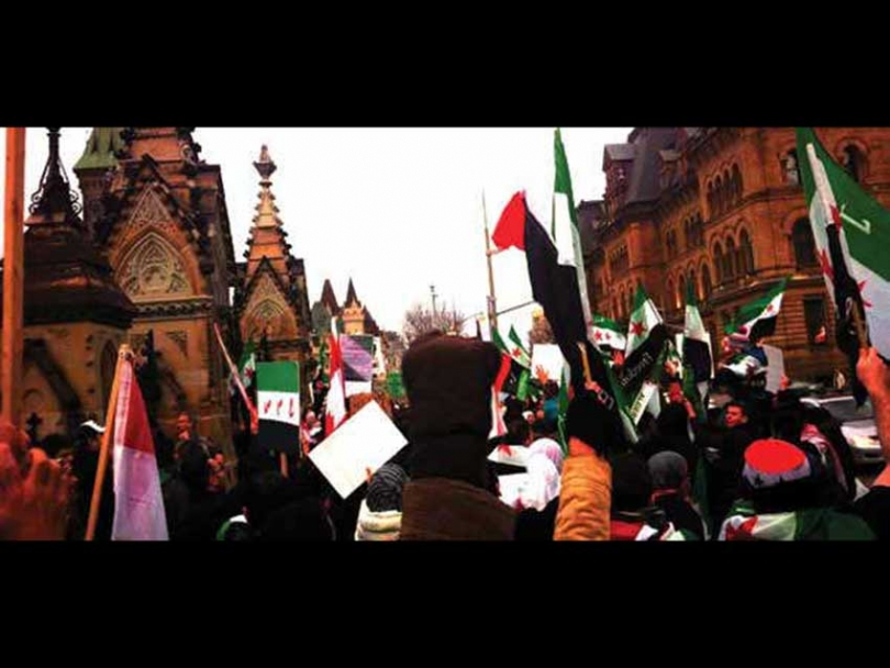 Hundreds of protesters march towards Parliament Hill demanding that the Canadian government recognize the Syrian National Council and expel the Syrian Ambassador.