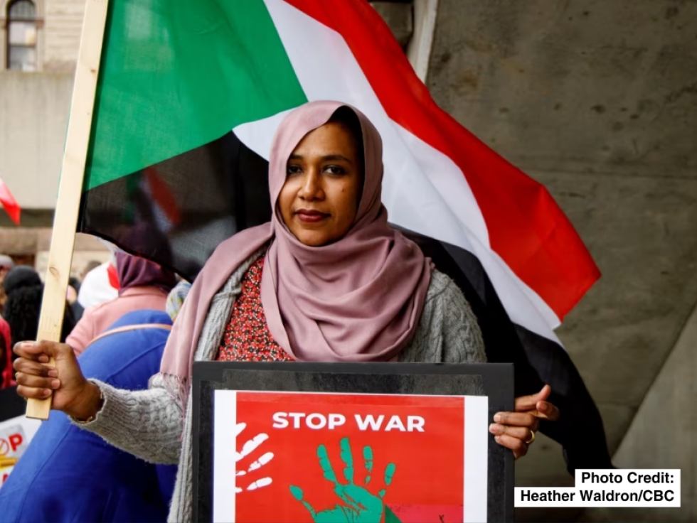 Randa Mohamed holds a sign that reads &#039;Stop War&#039; at Sunday&#039;s rally. 