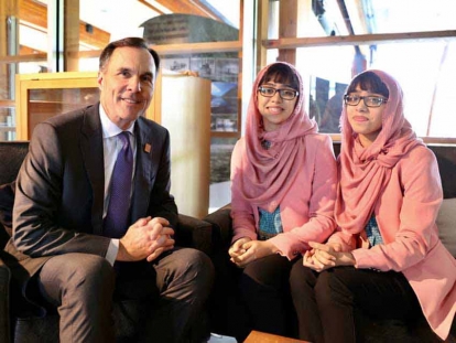 Maryam and Nivaal with Bill Morneau, Canada’s Finance Minister, at the G7 Summit