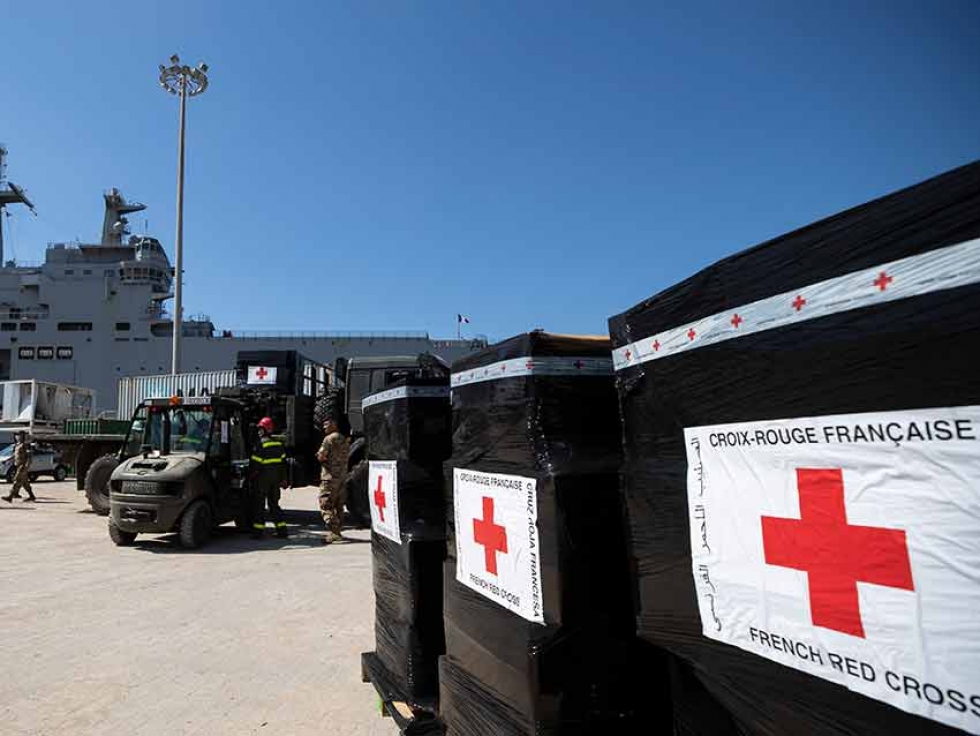French troops help unload boxes of French Red Cross humanitarian aid in Beirut on Aug. 17.