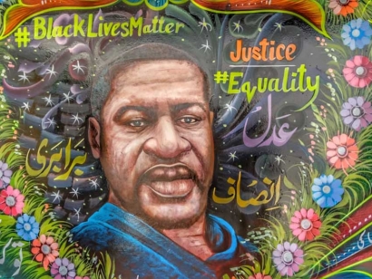 Pakistani truck artist painted a mural depicting George Floyd surrounded by a colorful heart-shaped garland of flowers, with slogans such as #Black Lives Matter on one side and #justice and #equality on the other.