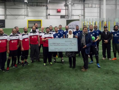 Imams presenting a cheque to Deen Support Services at the 2018 Imams Charity Soccer Game in Mississauga, Ontario.