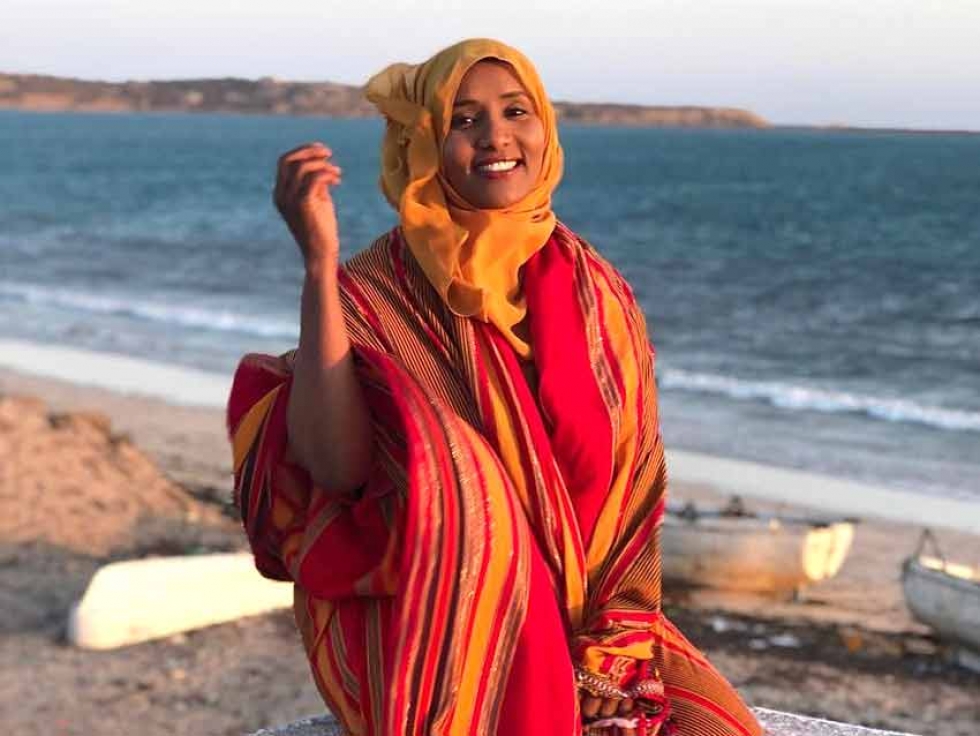 Hodan wearing traditional Somali colours in the port city of Kismayo. You can see the Indian Ocean behind her.
