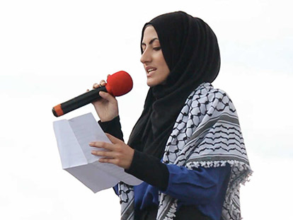 Haneen Al-Hassoun performing a poem at a demonstration in solidary with the people of Gaza July 2014