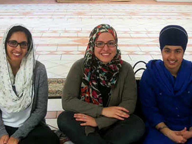 Sama (Centre) with friends Carla and Amanjot learning about turbans, which are also worn by Sikh women at a Sikh temple in Montreal.