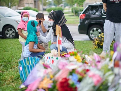 Mourners gather at the scene of the hate-motivated vehicle attack in London, Ont., which left four members of a Muslim family dead and sent their youngest son to hospital.