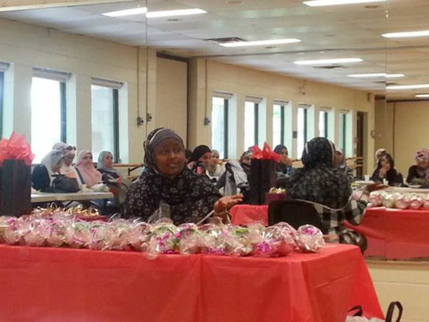 Amina Umuzayire discusses her charity with local Muslims.