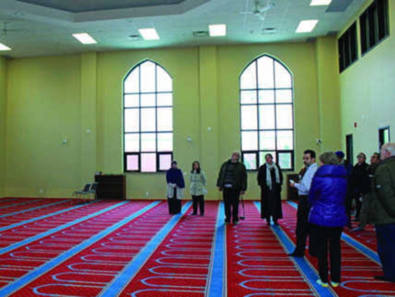 Participants on the Sustainability Bus Tour learn about the Bilal Mosque&#039;s green features.