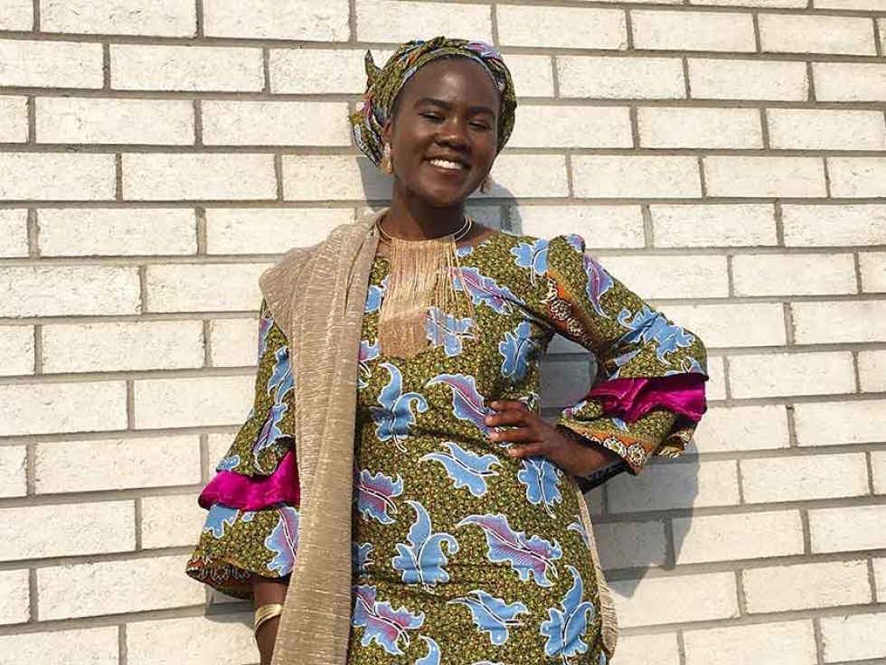Yoruba Nigerian Canadian Suliya Mazou sporting an ankara print dress and gele (headwrap).