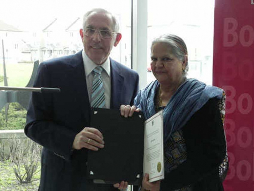 Safia Rasheed accepts her Leading Women, Leading Girls Building Communities from Ottawa West &amp;rdquo;&amp;ldquo; Nepean MPP Bob Chiarelli.