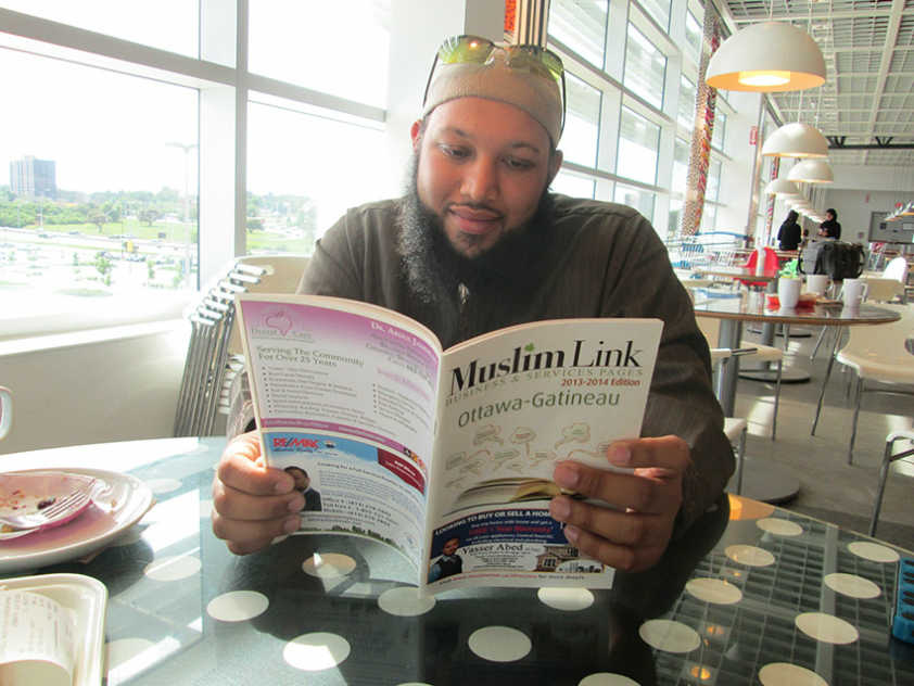 Pakistani Canadian imam reads Muslim Link’s Business Pages during a meeting with the paper this month