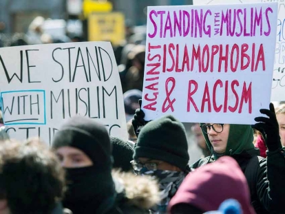 People hold signs during a protest in Montréal against Islamphobia in 2017.